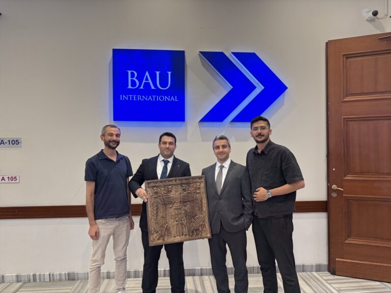 Lord Agency team visiting the Bahçeşehir University International Office in Istanbul with a Persepolis-inspired carved wooden relief