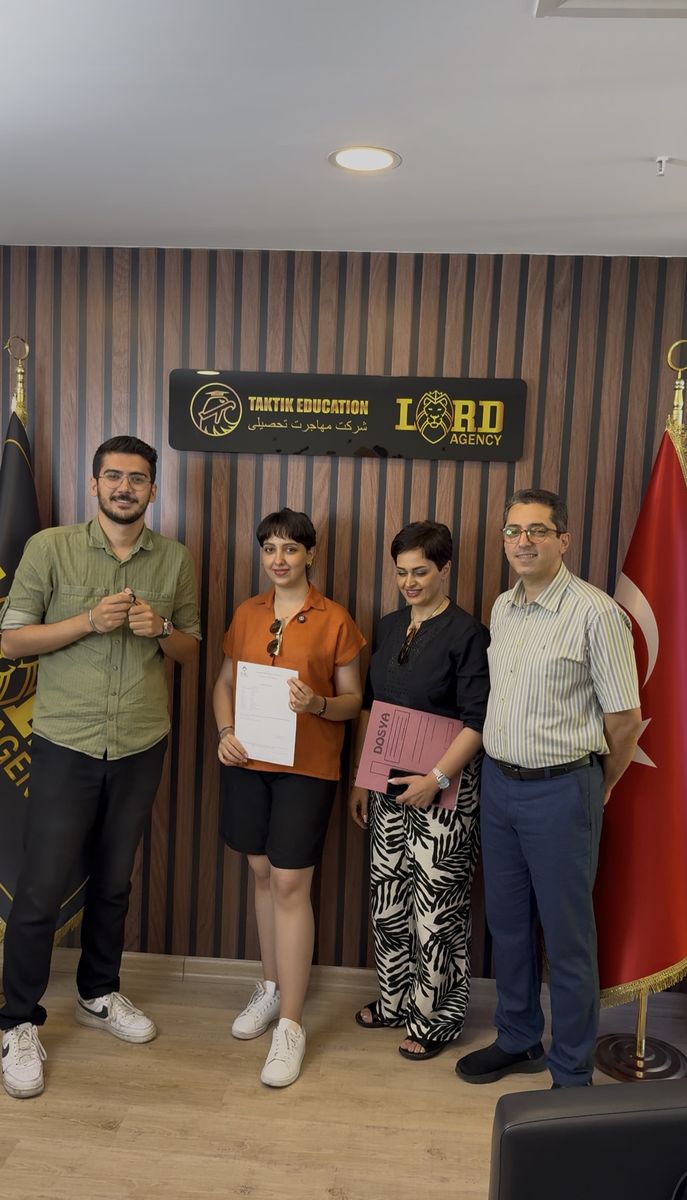 A student receiving her university acceptance letter at the Lord Agency office